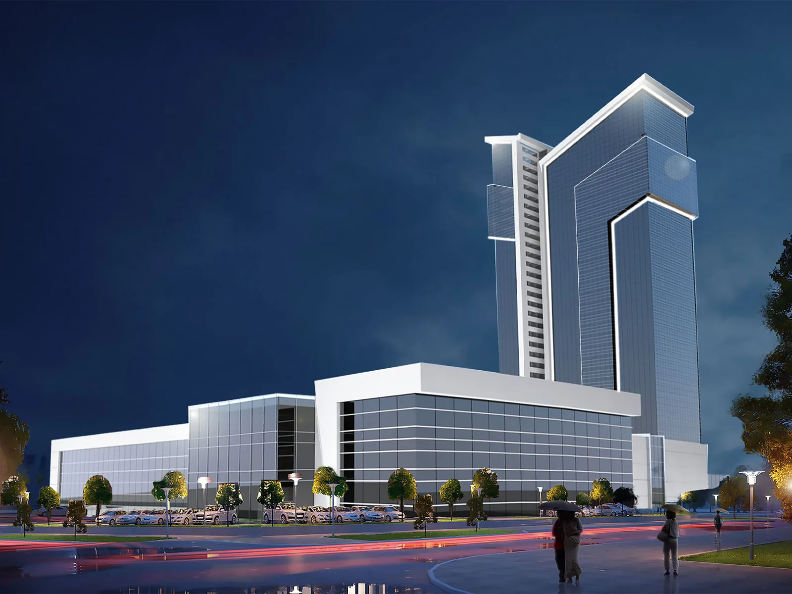 Culture Centre at night — an illuminated tower rising above a glazed public podium